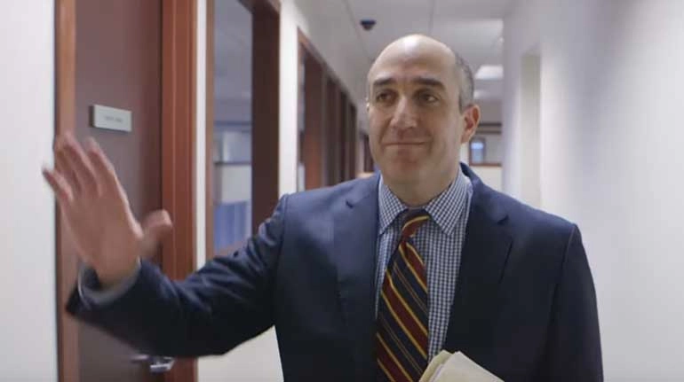 Mark Bernstein waving inside office