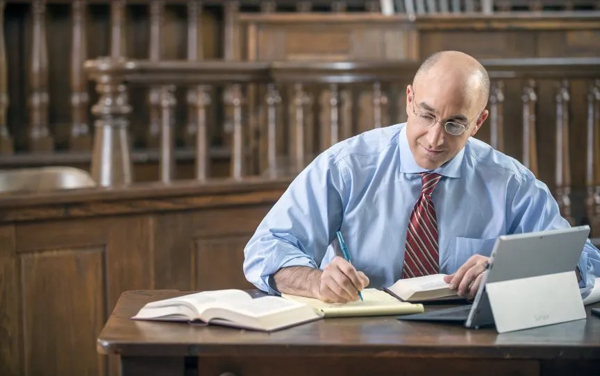 Mark Bernstein writing at desk