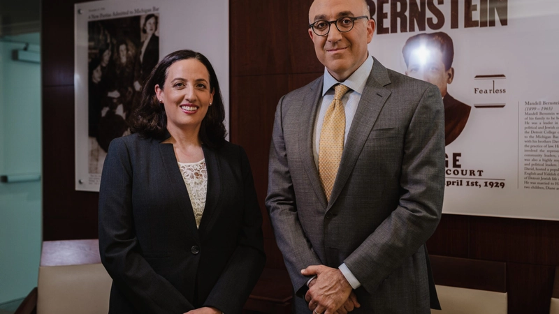 Mark Bernstein and Beth Bernstein Miller standing together in office