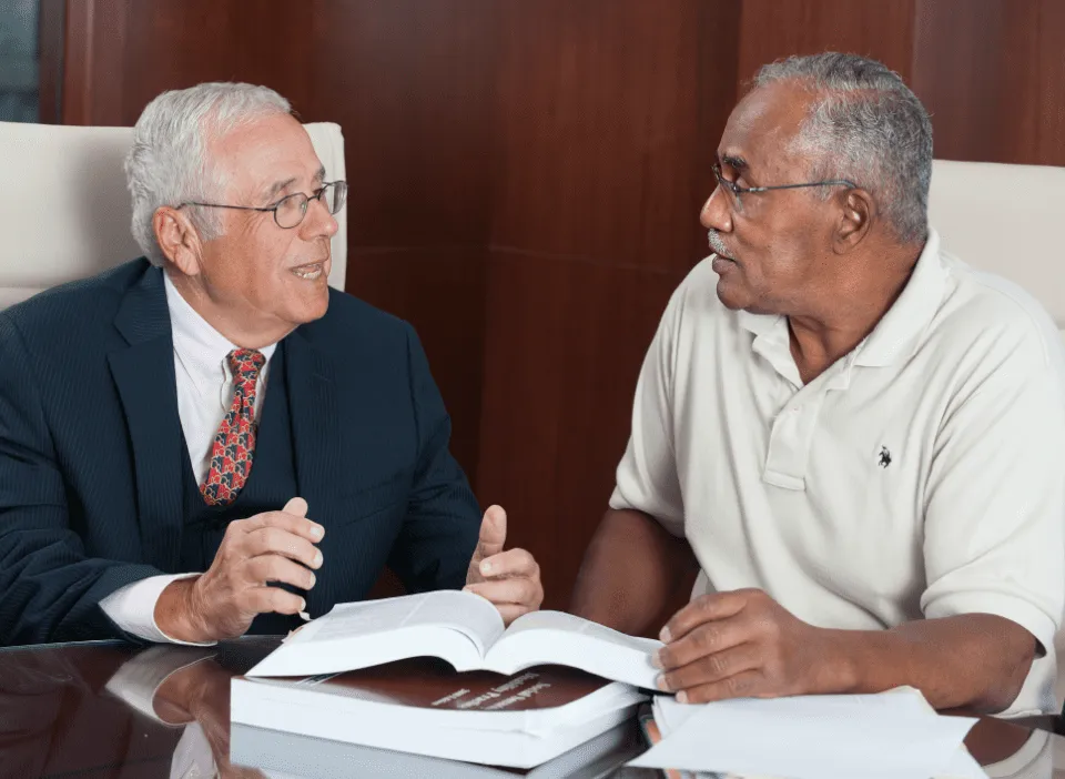 Sam Bernstein speaking to a client at desk