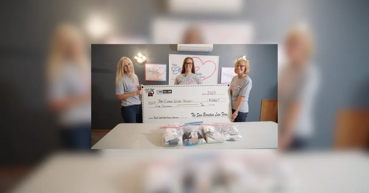 3 women holding large format check