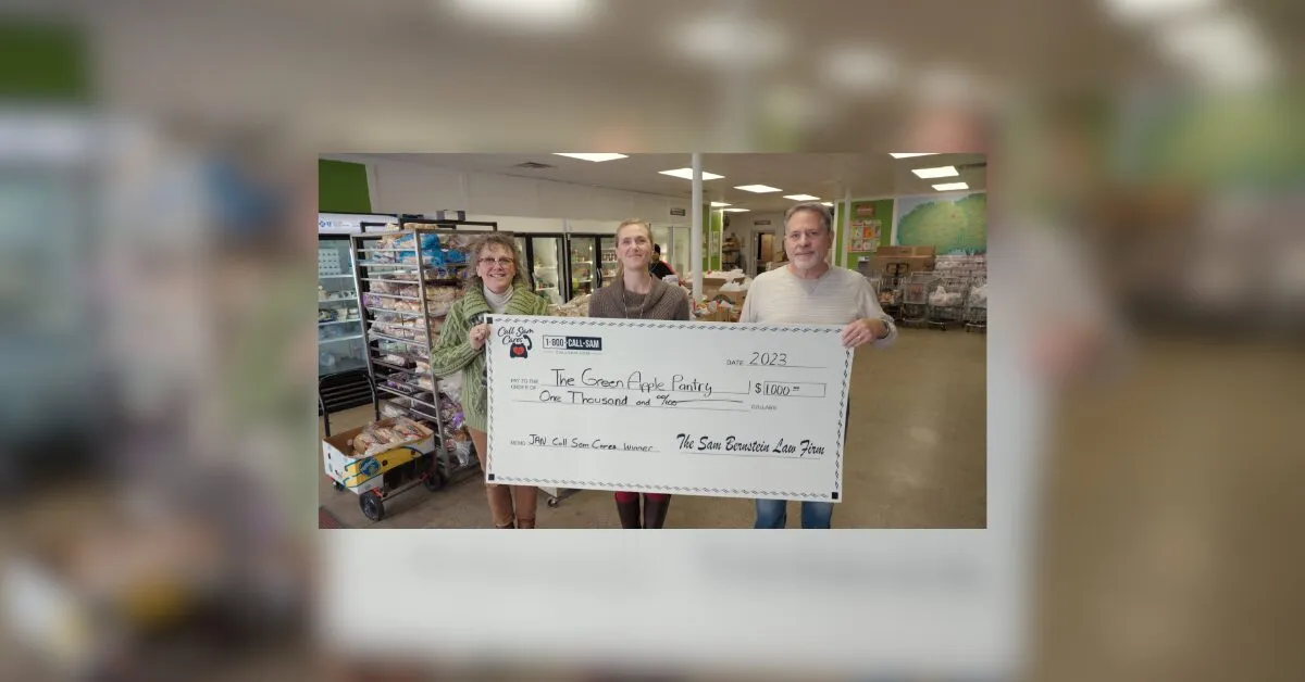 3 people holding large format check