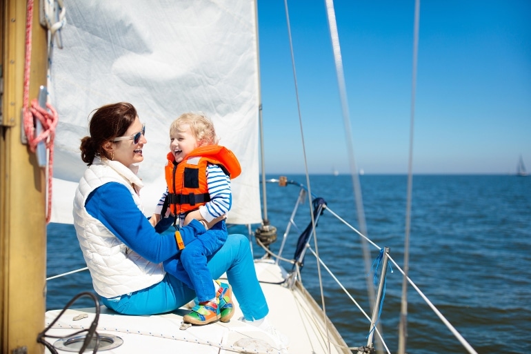 mother and child on boat, life jacket