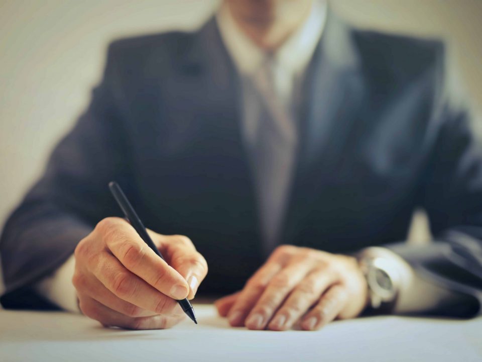 businessman writing with pen