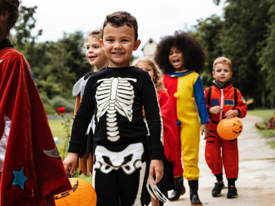 Young,Kids,Trick,Or,Treating,During,Halloween