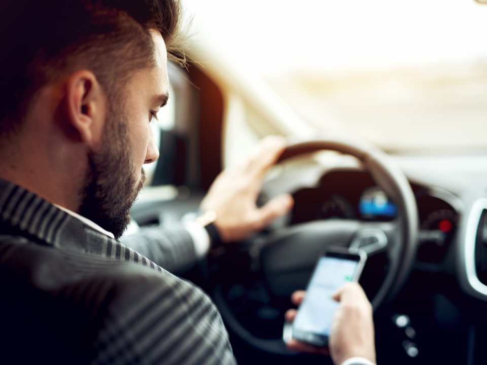 Man using cellphone while driving