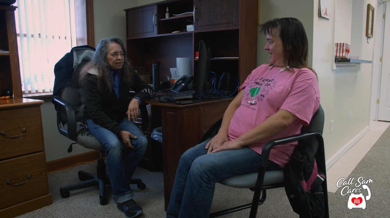 Staff at The Arc of Bay County meeting with a client in the office.