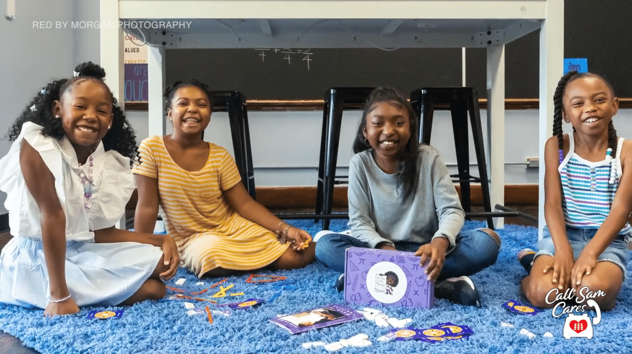 group of young girls sitting down showcasing a subscription box