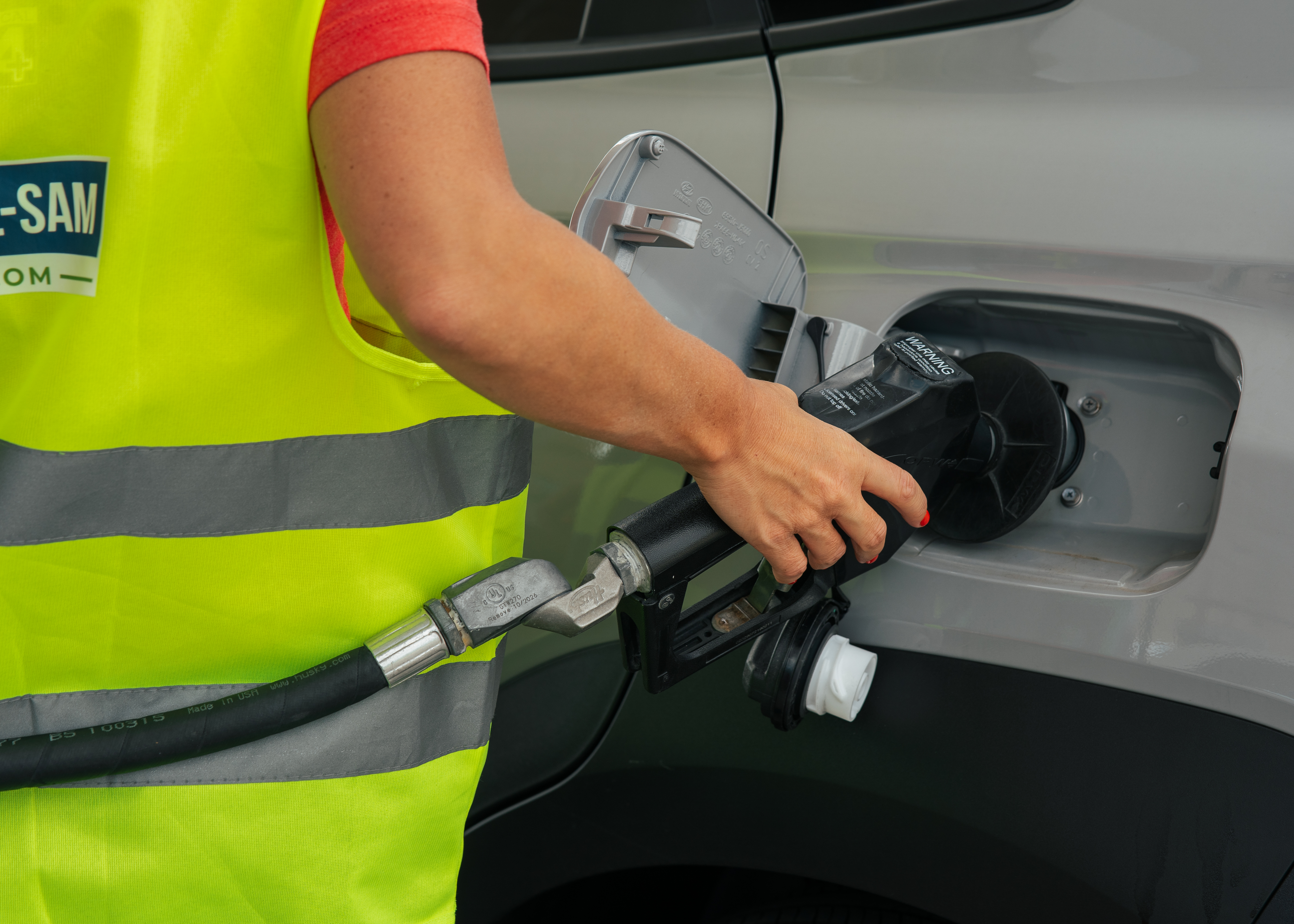 person pumping gas into a car