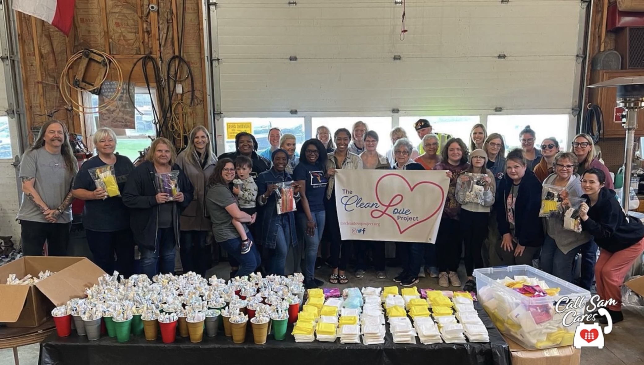 group photo of several people showcasing their hygiene kits that have been made