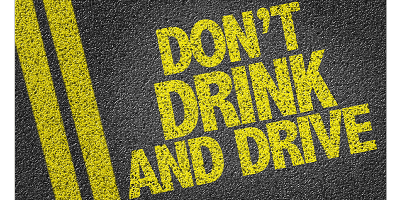 words that say Don't Drink And Drive in yellow painted on the cement road