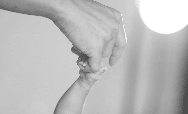 Adult Hand Holding Baby Hand