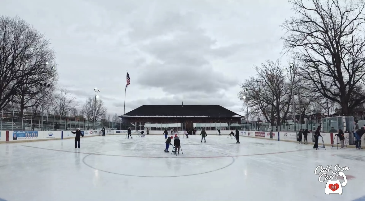 several people ice skating at a city park