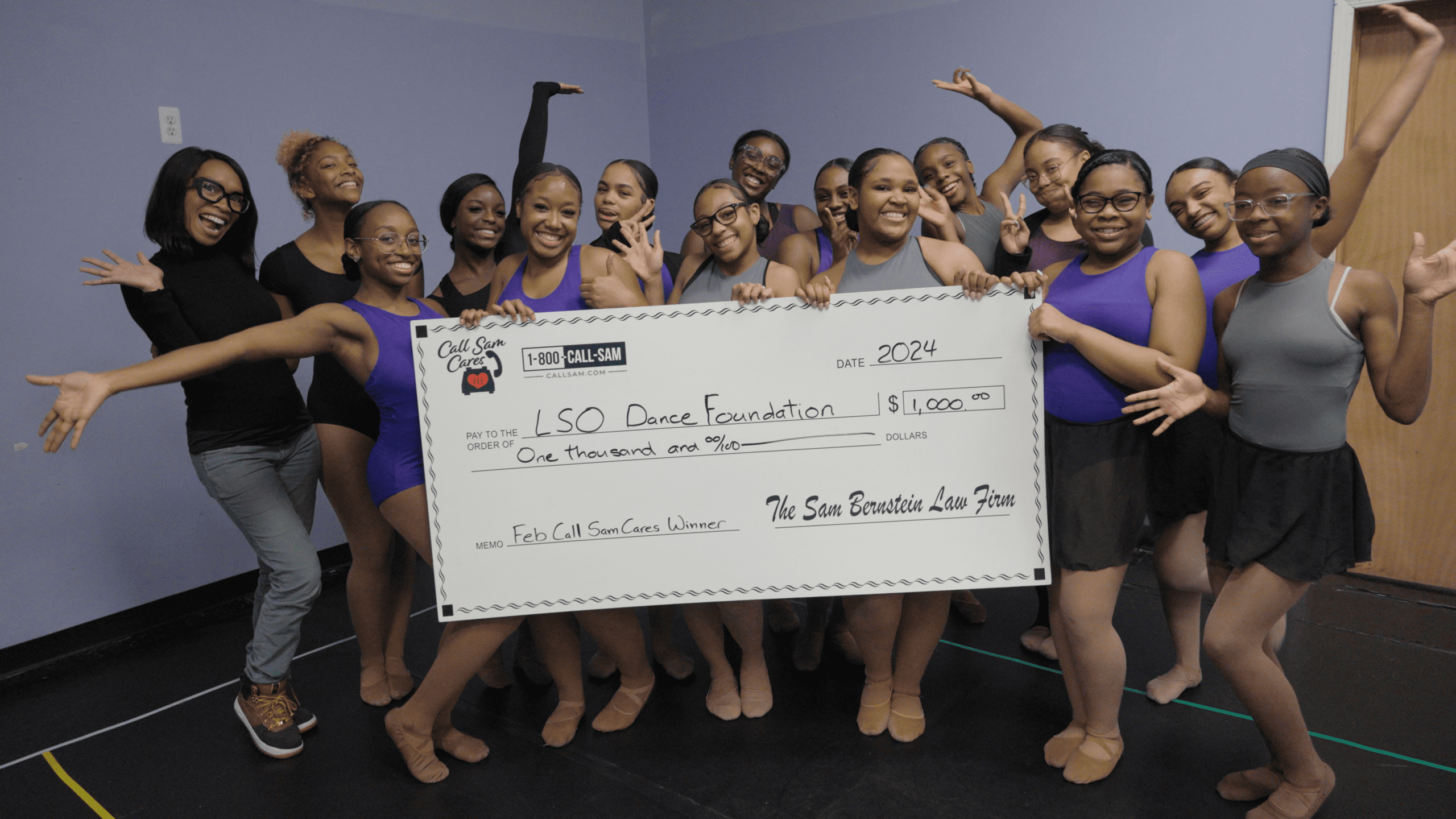 Girls at Dance Center holding large format check