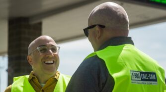 Mark Bernstein talking to man at gas giveaway event