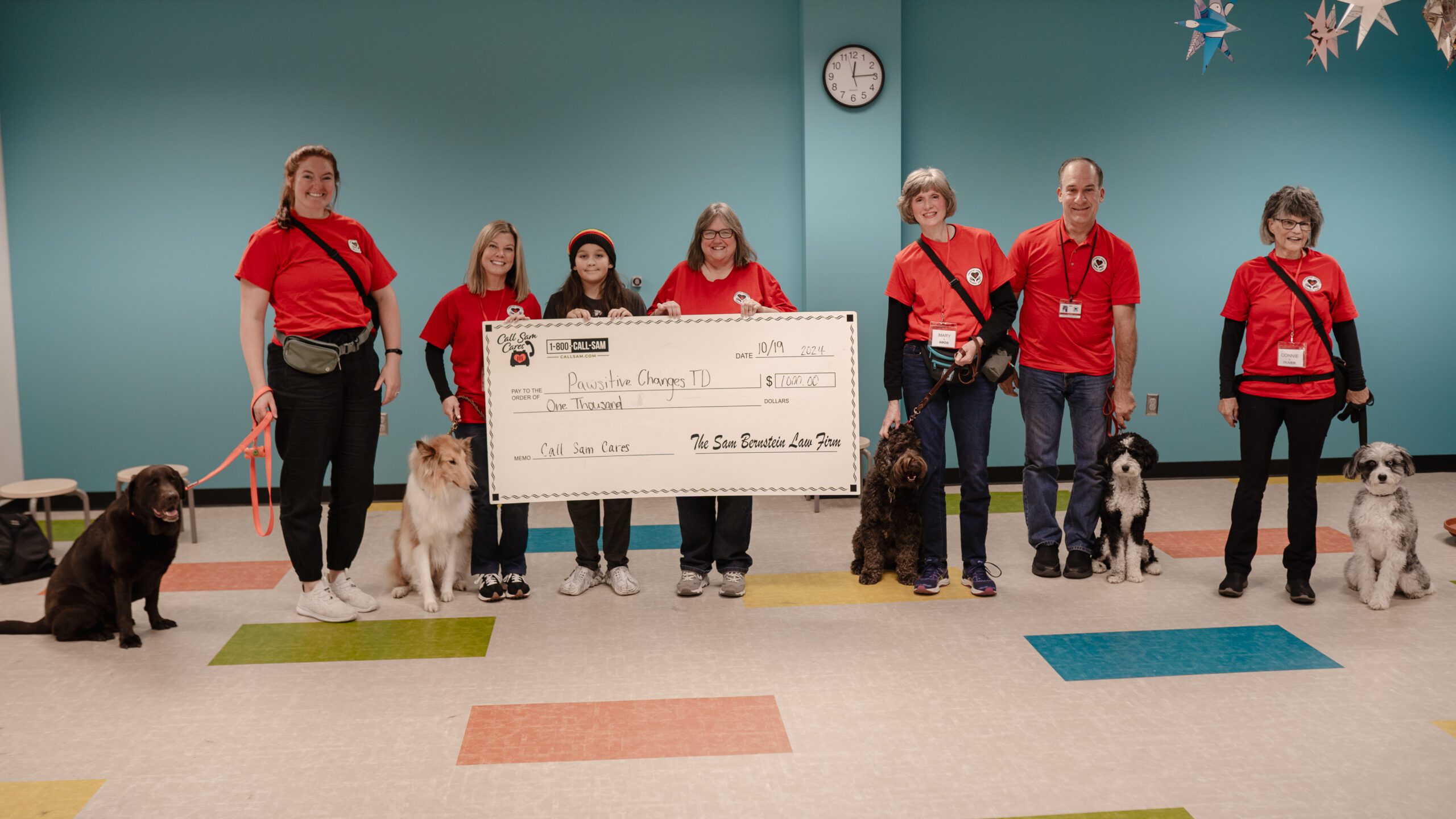 Group in red shirts with large format check