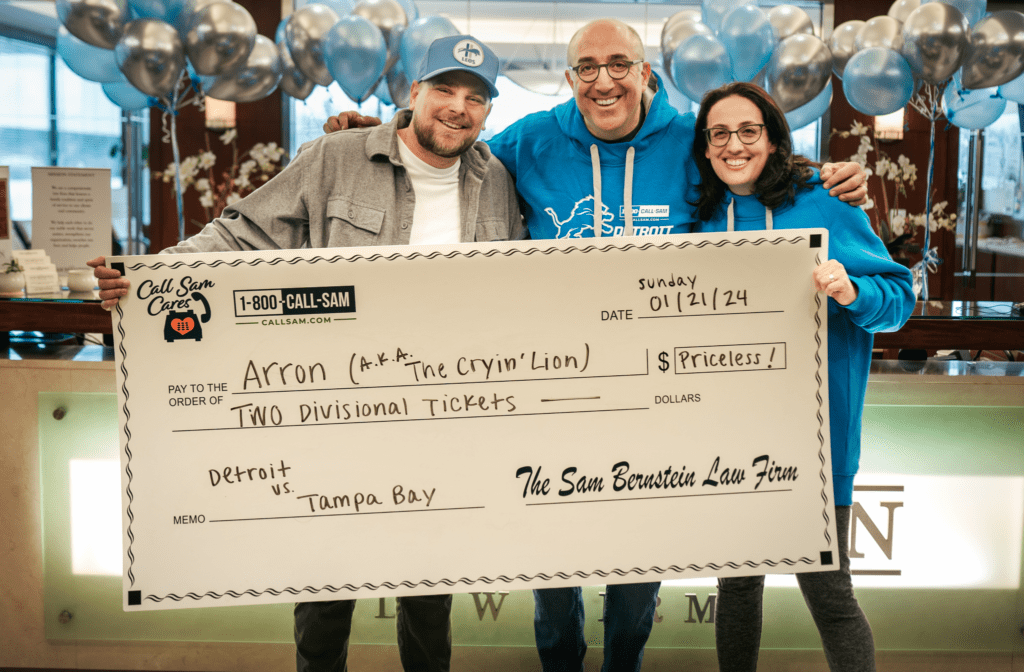 Mark Bernstein and Lions fan holding large format check