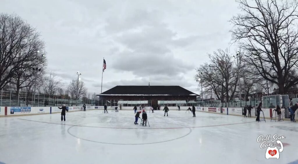 People skating at outdoor ice skating rink
