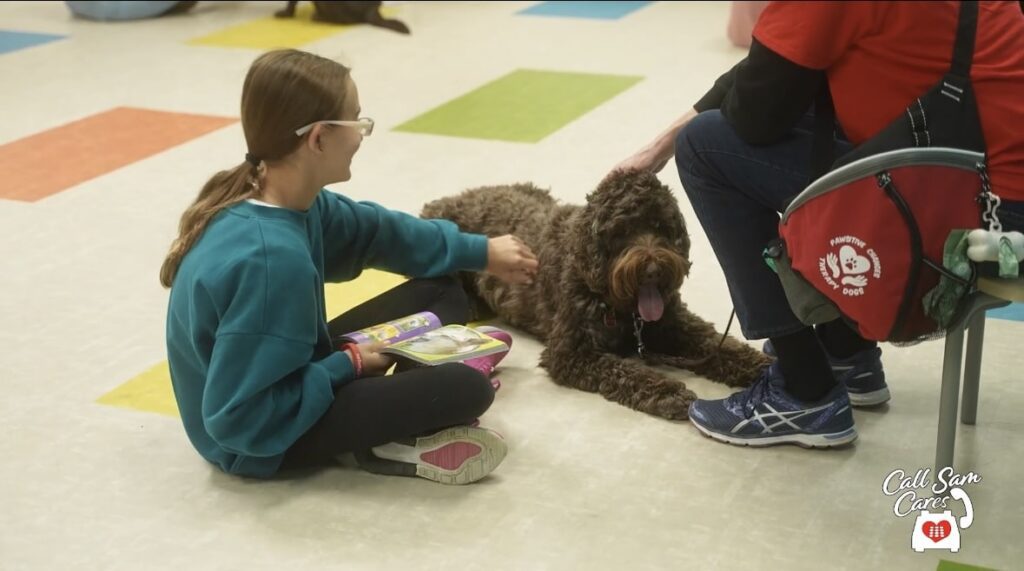 Girl playing with dog on floor
