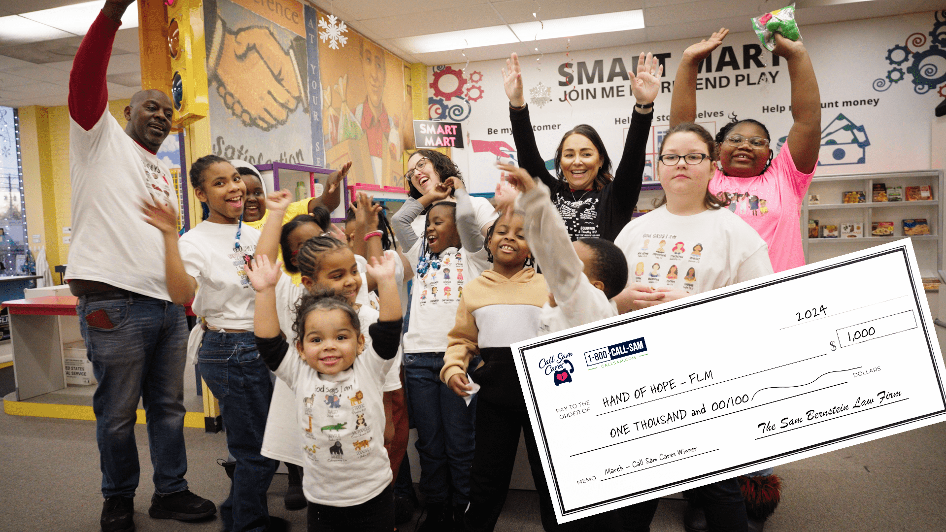 Teachers and kids putting hands up and one person holding large format check