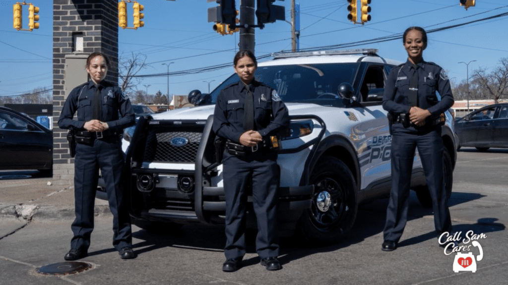 3 cops standing in front of cop car