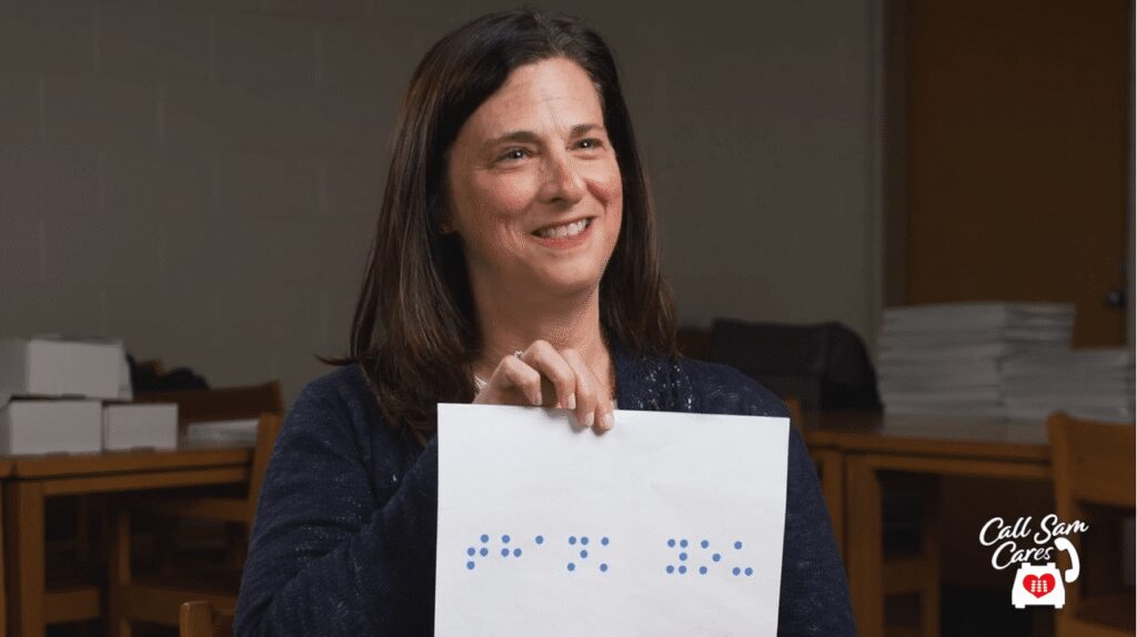 woman holding card with braille