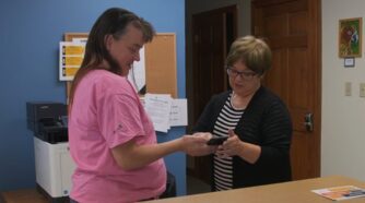 2 women looking at a phone