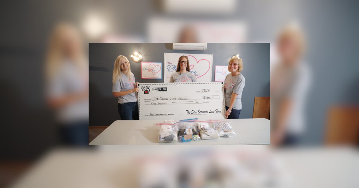 3 women holding large format check