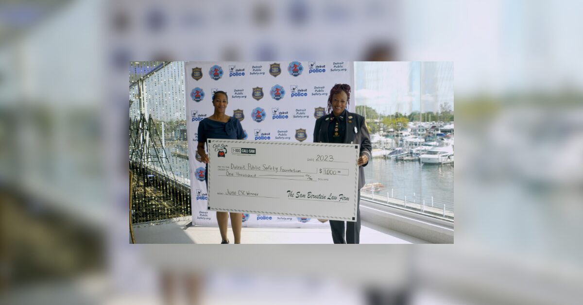 2 women holding large format check