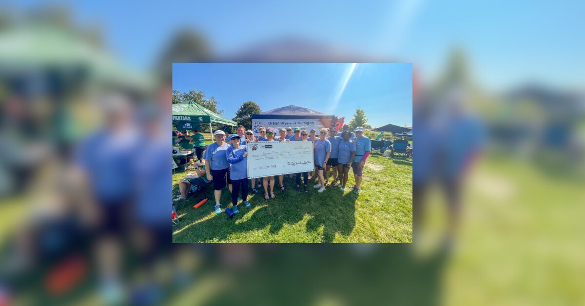 Dragonflyers team with large check