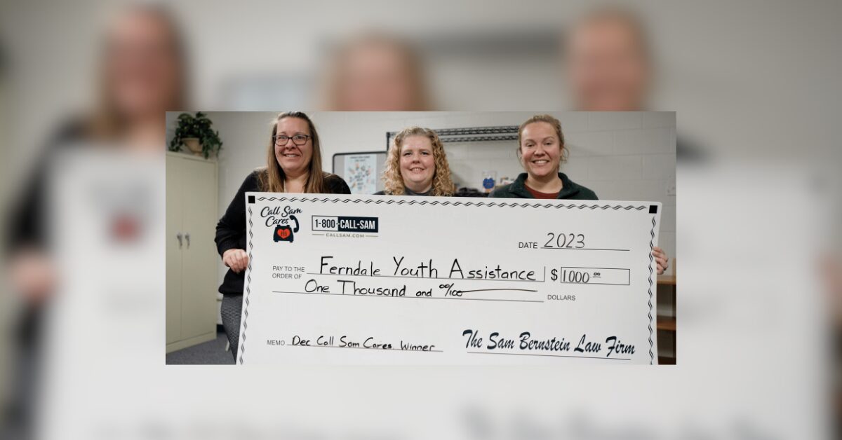 3 women holding large format check