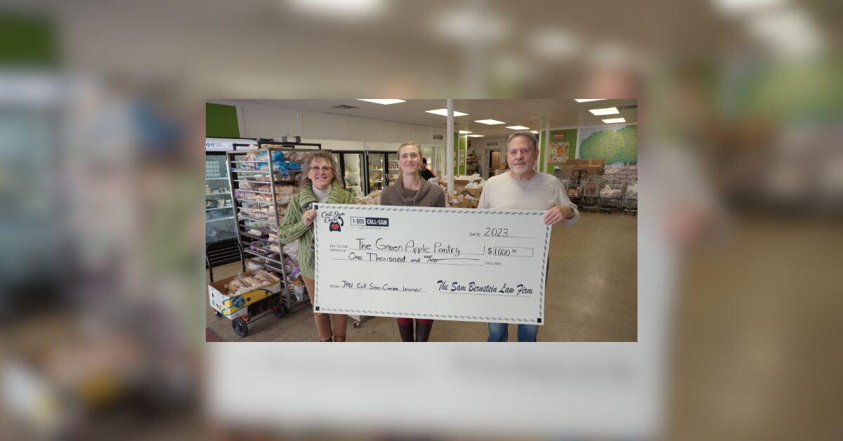 3 people holding large format check