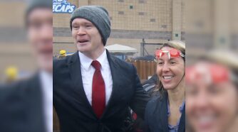 Man and woman at polar plunge event looking cold