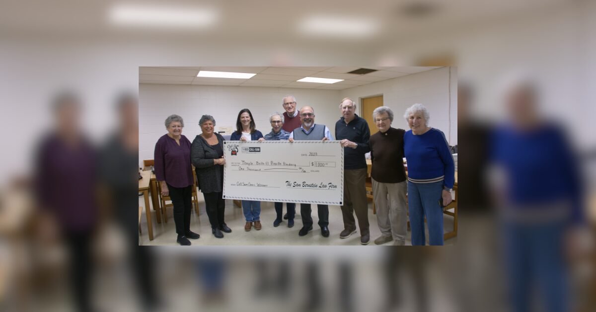 group posing with large format check