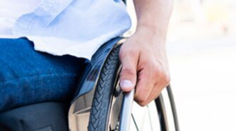 Hand gripping side of wheelchair